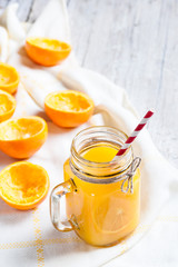 Orange juice with remains of shells in glass jar.