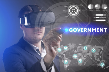 Business, Technology, Internet and network concept. Young businessman working in virtual reality glasses sees the inscription: Government