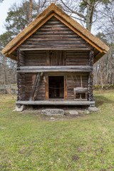 Old log barn with a thatched roof. Tallinn open-air museum ,Estonia.