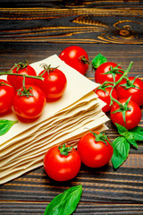 dried uncooked lasagna pasta sheets and tomato