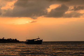 Sunrise  and shadow boat on sea near the beach ,Koh Samet Thailand