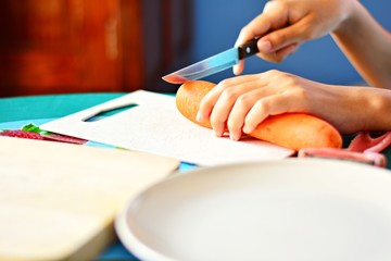 Cooks are preparing carrots. To cook Focus on the knife and carrot head, the background blurred.