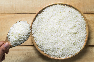 Close up  jasmine rice in  wooden spoon. top view