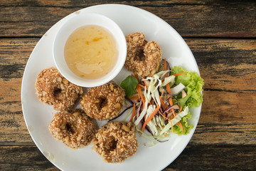 TOD-MUN-KUNG.THAI food on wooden table (wooden background)