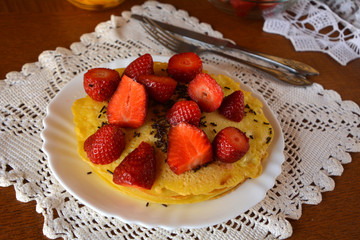 Sweet homemade pancakes with strawberries and chocolate. 
