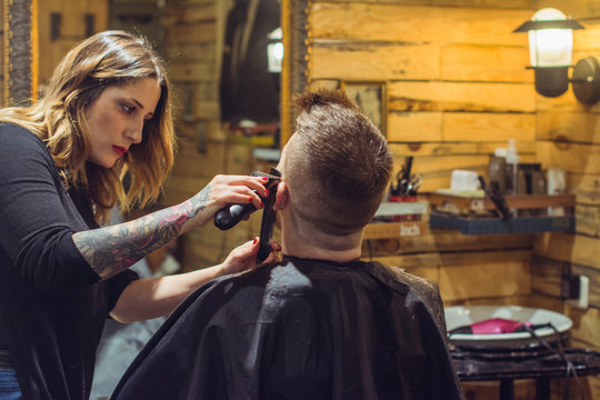 Woman Hairdresser Trimming Beard Of A Man In Salon