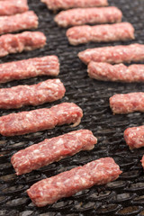 Grilling minced meat kebabs on the barbecue flat lay