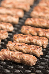 Grilling minced meat kebabs on the barbecue with selective focus