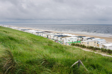 Grass Hill Overlooking a Beach on the Coast of North Sea in The Netherlands. Mobile Homes are all...