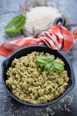 Frying pan with spinach risotto, vertical shot with shallow depth of field