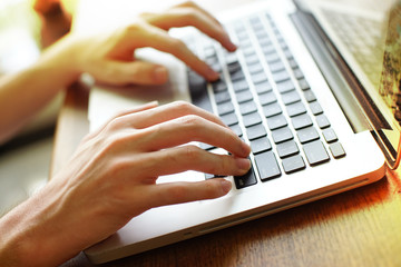 Hands typing on laptop computer. soft focus on keyboard.