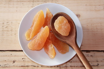 Dried pear on a White plate with a wooden spoon