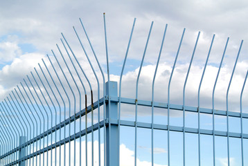 Fototapeta na wymiar metal gate with sky in the background
