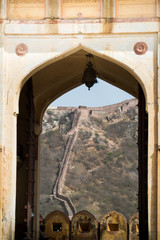 Frontier wall at Amber Fort Jaipur, Rajasthan, India. Amber Fort is the main tourist attraction in the Jaipur area. - 148477979