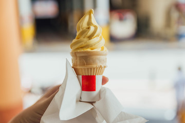 Pineapple yellow ice-cream cone with napkin in George Town. Penang, Malaysia. 