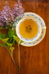 green tea in a vintage porcelain teacup with purple flowers