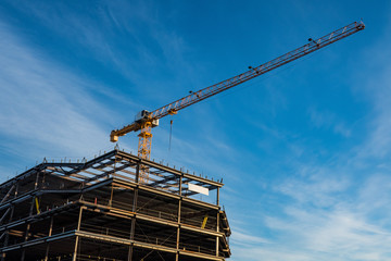 Naklejka premium Construction crane against blue sky