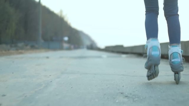 Beautiful woman roller-blading on the seashore 4k