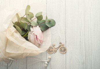 Bouquet, flower, wooden bike, earphones.