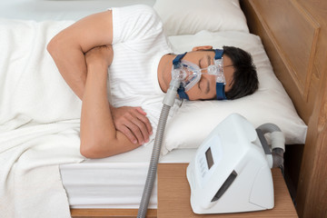 Sweet dream during long deep sleep.Continuous positive airway pressure  ,CPAP sleep apnea therapy.Happy and healthy senior man  breathing more easily during sleep without snoring .