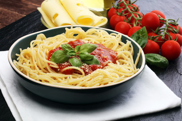Plate of delicious spaghetti Bolognaise or Bolognese with savory minced beef and tomato sauce garnished with parmesan cheese and basil