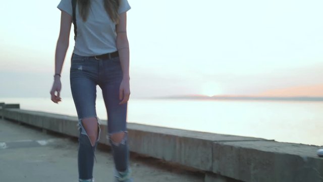 Beautiful woman roller-blading on the seashore 4k