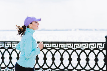 The girl is running along the embankment