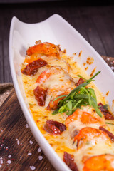 The tiger shrimps and gentle pieces of a salmon baked in creamy sauce
