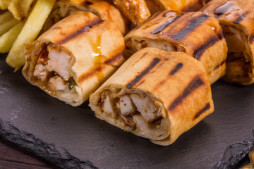 Shawarma with stuffing of the fried fillet, is served with French fries and vegetables