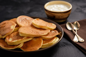 Homemade pancakes on black background.