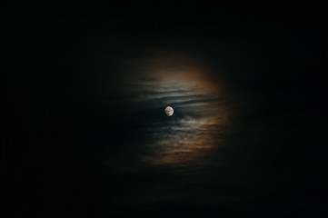 Full moon on a nighttime expressive sky with clouds. Colorful.