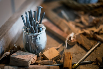Carpentry workshop background with nails and sawdust, Detail craft workshops, Background desk in workshop, Metal nails on table still life