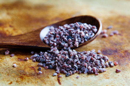 Himalayan black rock salt Kala Namak pungent-smelling condiment used in South Asia, Himalayas, Pakistan. Macro view soft focus.