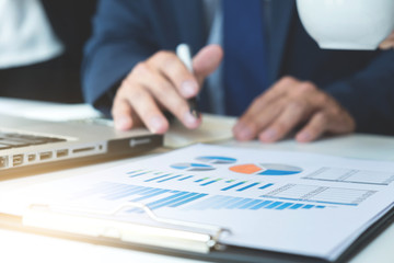 Business team meeting working with new startup project.discussion and analysis data the charts and graphs. Digital tablet laptop computer using,Business finances and accounting concept