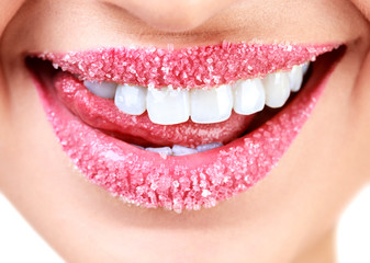 Closeup of woman's lips covered with sugar