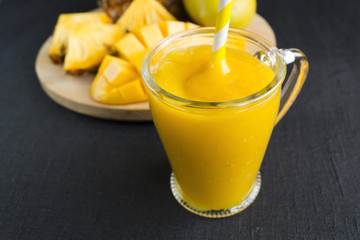 juice and smoothies of tropical fruits. pineapple and mango