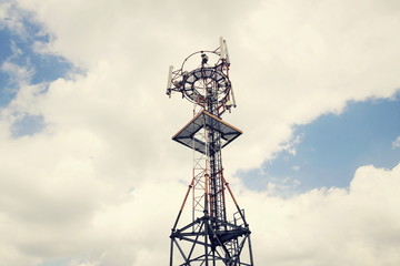 Transmitters and aerials on telecommunication tower during sunset