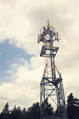 Transmitters and aerials on telecommunication tower during sunset