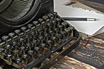 vintage keyboard of writing machine with pen