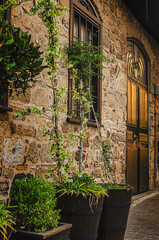Old city street: stone stairway, flowers, doors and windows. Kaleici, Antalya, Turkey