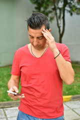 Naklejka premium Portrait of handsome young man using a smartphone