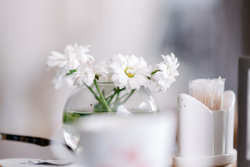 Fototapeta na wymiar Vase with flowers in a cafe