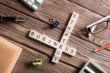 Conceptual business keywords on table with elements of game making crossword