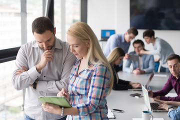 Two Business People Working With Tablet in office