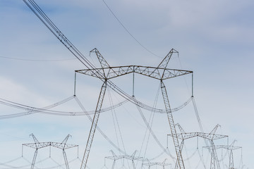 High-voltage power lines against the blue sky.