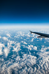 Naklejka na ściany i meble blue sky and clouds. View from the airplane window
