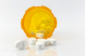 bottle with white pills isolated on a white background