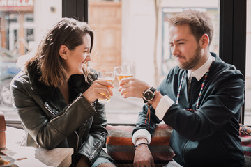 Couple toasting at the bar. Drinking beer and having a good time with lots of love.