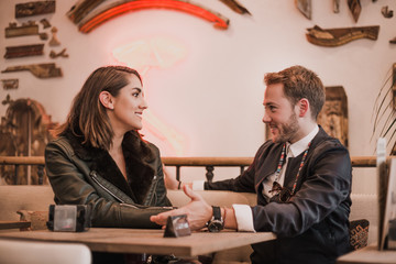 Friends having a good time at the bar. Couple having fun at the bar. Friends chatting at the bar. Couple talking in restaurant. Couple having breakfast