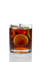 Cocktail with rum and cola with ice, lime and lemon in oldfashioned glass isolated on white